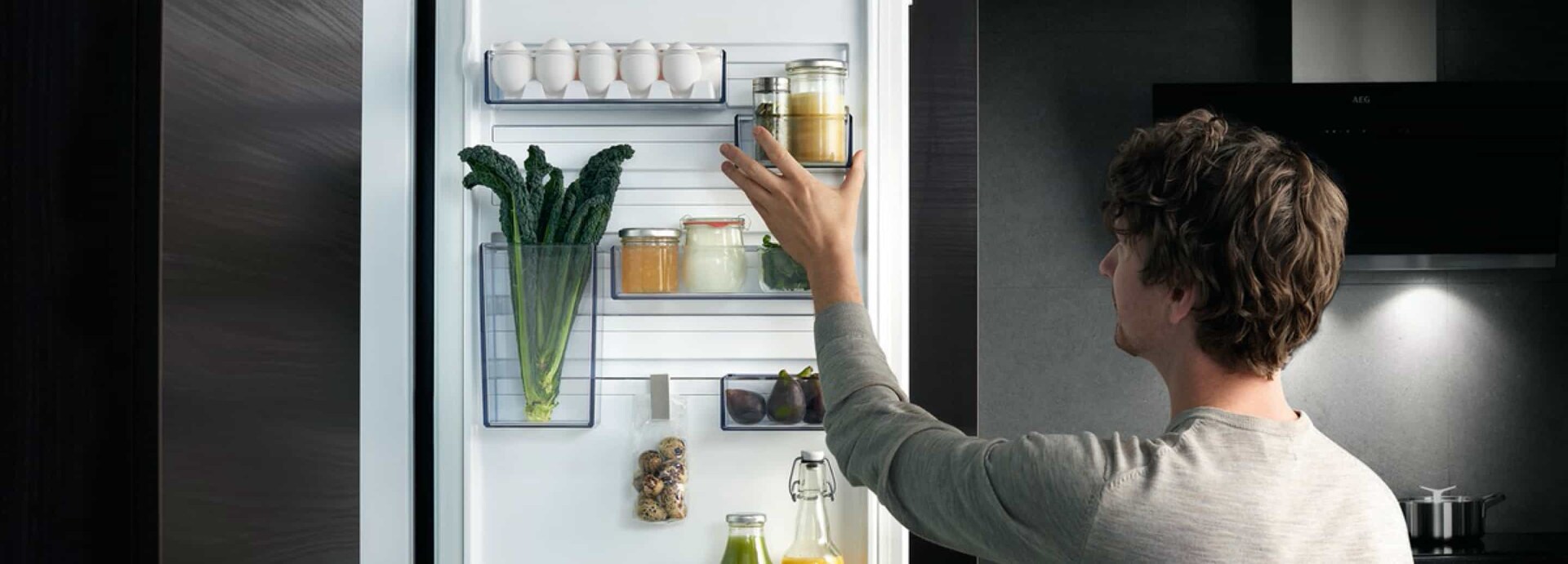 A man organizing his fridge with CustomFlex®